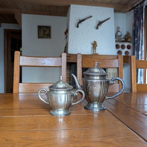 Vintage silver plated sugar bowl and coffee pot set with handles and lid for an elegant tea set from England