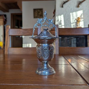 Vintage metal censer with ornate floral relief and decorative lid for religious altar or spiritual incense rituals