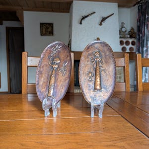Pair of vintage embossed copper handmade oval shaped wall decor with motif of girls at the harvest