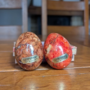 A pair of vintage decorative real alabaster eggs in orange and brown colors for Easter decor collecting stone eggs