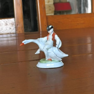 Vintage Hungarian hand-painted porcelain figurine of a boy riding a goose by Herend 5415