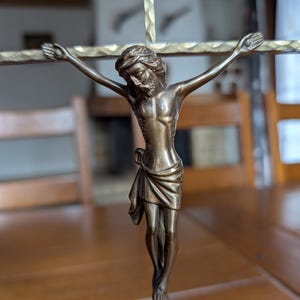Vintage brass wall crucifix with detailed figure of Jesus depicting the Crucifixion from mid-century West Germany for home altar decor