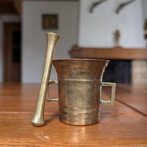 Vintage brass mortar and pestle with double handle from Europe for herbal kitchen decor or apothecary collection