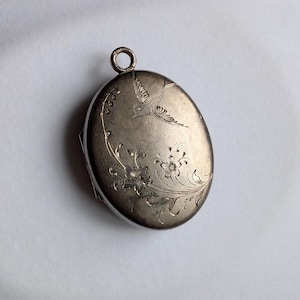 Antique Victorian silver oval locket for two photos with engraved bird and flowers