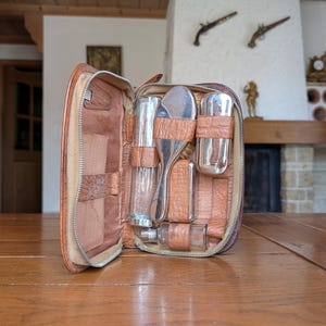 Vintage mens grooming travel set in leather case with chrome brushes and glass bottles as a gift for retro travel or Father&#39;s Day