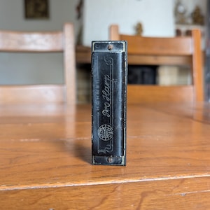 Hohner Pro Harp vintage black harmonica in metal case from Germany for musical instrument collectors or blues musicians