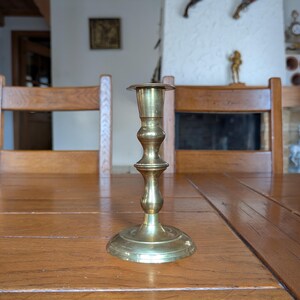 Vintage tall brass candlestick holder with classic turned design for traditional home decor or holiday table centerpiece
