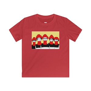 May include: Red t-shirt featuring a graphic of five figures with red hats and turtlenecks, set against a yellow background. The figures are wearing black and white striped shirts. A casual, artistic design.