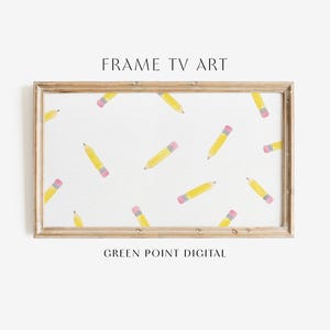 May include: A framed digital art print for a TV screen. The artwork features a white background with scattered yellow pencils with pink erasers. The frame is a light brown color. The text "FRAME TV ART" and "GREEN POINT DIGITAL" are displayed.