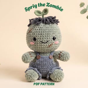 May include: A crocheted plush doll named Sprig the Zombie with sage green yarn, dark gray hair, and a small green sprout on top. The doll wears blue overalls with two brown buttons, has black eyes, pink cheeks, and stitched scars on its face.