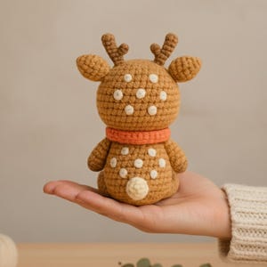 Hand holding a fox mini plush beside a ruler to show 5–7 inch finished size; perfect pocket-size woodland crochet toy.