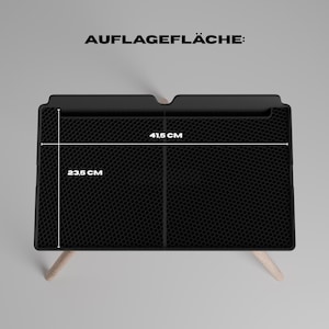 Peut inclure: Un plateau rectangulaire noir avec une surface textur&eacute;e en nid d'abeille et des pieds en bois clair. Le texte AUFLAGEFL&Auml;CHE est visible au-dessus du plateau, avec des lignes de mesure indiquant une largeur de 41,5 cm et une profondeur de 23,5 cm.