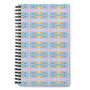 May include: A spiral-bound notebook. The light blue cover has a repeating floral pattern in pink, yellow, orange, and green. The notebook's spiral binding is black.