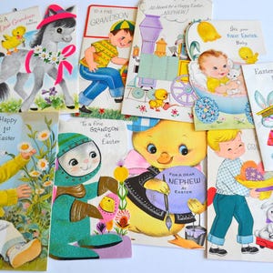 May include: A collection of vintage Easter greeting cards. The cards feature illustrations of children, animals, and Easter themes. Some cards have text like "Happy 1st Easter" and "For a Dear Nephew at Easter."