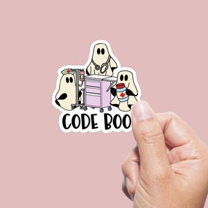 May include: A sticker featuring three cartoon ghosts in medical attire. One ghost wears a nurse's cap and stands near a medical cart. Another ghost has a stethoscope, and the third holds a container with a medical cross. The text "CODE BOO" is below.