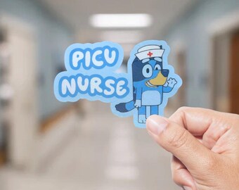 May include: A light blue sticker with the words "PICU NURSE" in white bubble letters. The sticker features a cartoon dog character wearing a nurse's hat with a red cross. The dog is blue with black markings and is waving.