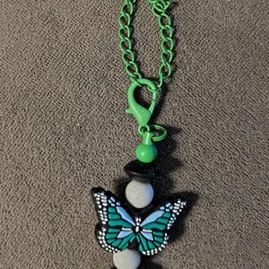 Dije de asa de taza con forma de mariposa