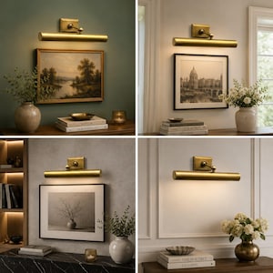 May include: A brass picture light fixture with a cylindrical lamp head and a rectangular wall mount. The light is mounted above framed artwork, casting a warm downward glow. The fixture features a metallic finish and an adjustable arm.