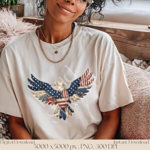 May include: A cream-coloured t-shirt with a patriotic eagle design. The eagle's wings display a blue star pattern and red and white stripes, representing the American flag. The shirt is a digital download, 5000 x 5000 px, PNG, 300 DPI.