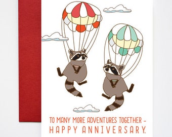 Biglietto di auguri di buon anniversario con procioni che si tuffano nel cielo