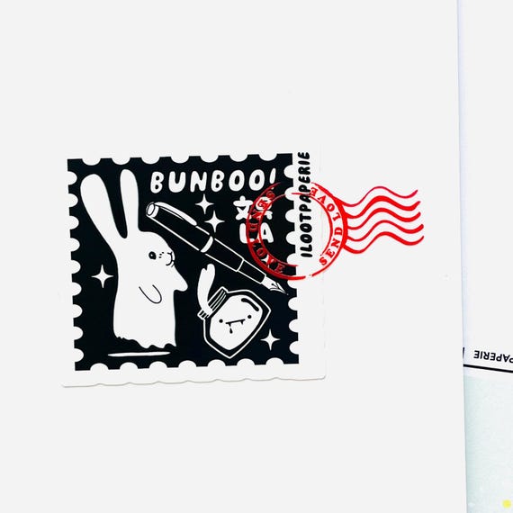 Postcard featuring our Bunboo! Stamp Sticker overlapped with a Send Love Postmark Sticker on a BunguLA 文具 6" x 4" A6 in Size
