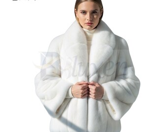 May include: A white fur coat with a wide collar and long sleeves. The coat is buttoned at the front and appears to be made of a soft, luxurious material. The model is wearing blue jeans.