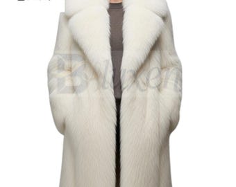 May include: A long, white faux fur coat with a wide collar and long sleeves. The coat is open in the front, revealing a glimpse of the wearer's clothing. The coat has a luxurious appearance and is suitable for cold weather.