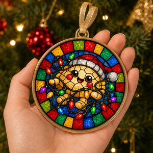 May include: A round stained glass ornament featuring a smiling turtle wearing a red and white Santa hat, tangled in colorful Christmas lights. The design is framed by a gold border with a gold ribbon loop for hanging, set against a dark background.
