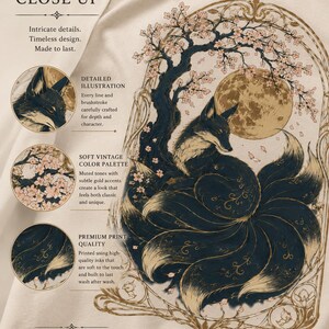May include: A cream-coloured t-shirt featuring a detailed graphic of a nine-tailed fox sitting under a flowering tree and a large moon. The illustration is framed by an ornate archway and includes text such as ARTWORK CLOSE UP, DETAILED ILLUSTRATION, SOFT VINTAGE COLOUR PALETTE, PREMIUM PRINT QUALITY, and PRINTED ON COMFORT COLORS 1717.