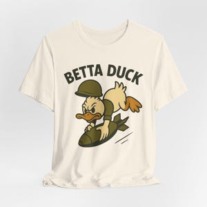 Betta Duck Bomb Rider T-Shirt: Retro Cartoon Military Nose Art Style image 9
