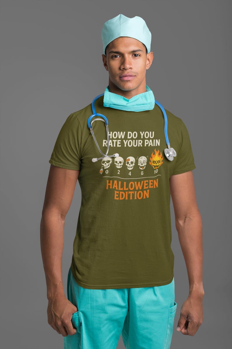 May include: Olive green t-shirt with the text "HOW DO YOU RATE YOUR PAIN" and "HALLOWEEN EDITION" in orange. The shirt features a pain scale with skulls, ranging from 0 to 10. A person is wearing the shirt, a blue surgical cap, and a stethoscope.