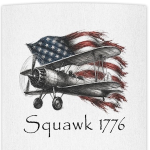 May include: A white fabric surface featuring a detailed black ink sketch of a vintage biplane flying in front of a waving American flag. The text Squawk 1776 is printed in a black serif font below the illustration of the aircraft and flag.