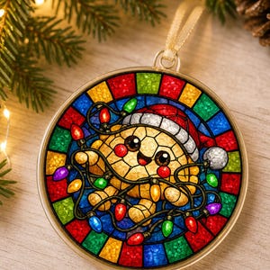 May include: A round ornament featuring a stained-glass style design of a smiling yellow creature wearing a Santa hat and tangled in colorful Christmas lights. The border consists of alternating red, blue, green, and yellow glass-like segments.