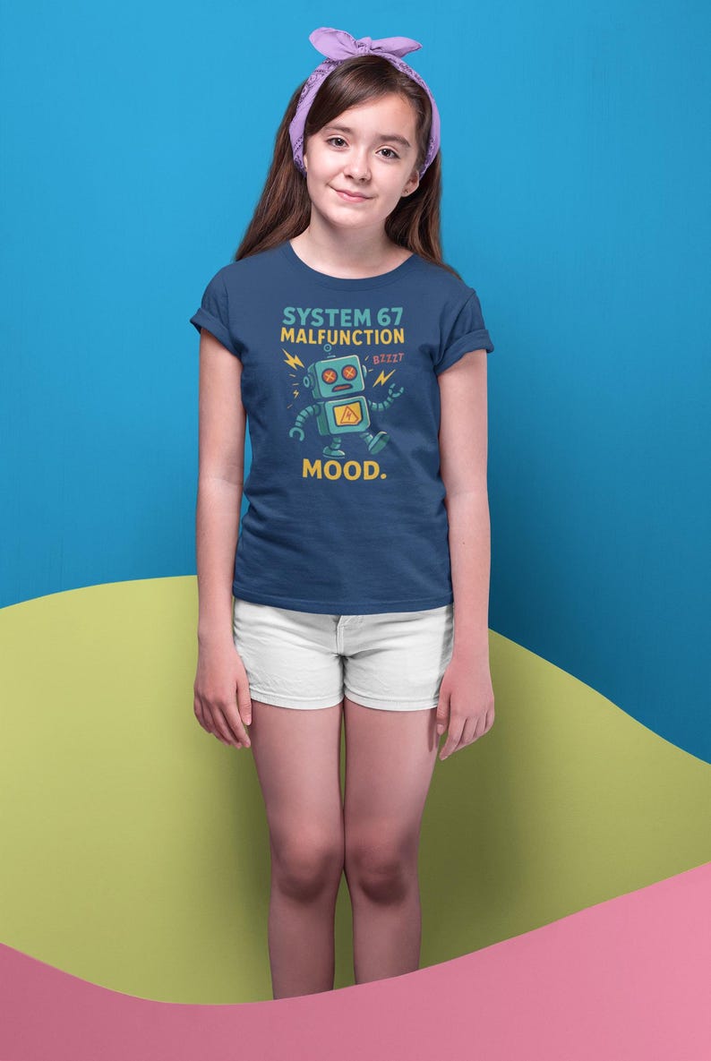 May include: Navy blue t-shirt with a robot graphic and the text "SYSTEM 67 MALFUNCTION MOOD." The robot is light blue with yellow accents. The person is wearing white shorts and a purple headband.
