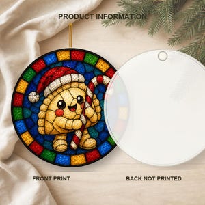 May include: A round ceramic ornament featuring a stained glass style illustration of a smiling dumpling wearing a Santa hat and holding a candy cane. The front displays the colorful graphic, while the back is plain white with a small hanging hole.