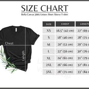 May include: A black Bella Canvas 3001 unisex short sleeve t-shirt with a size chart. The chart shows chest and length measurements in inches and centimetres for sizes XS to 3XL. The shirt has a sprig of green leaves.