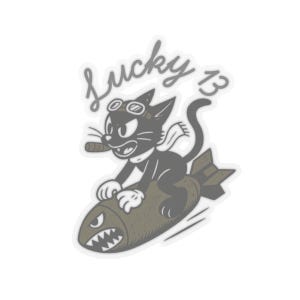 May include: A sticker featuring a black cartoon cat wearing goggles and a scarf, holding a cigar while riding a bomb with a shark-mouth nose art design. The text Lucky 13 is written in a cursive script above the cat in a grey color palette.