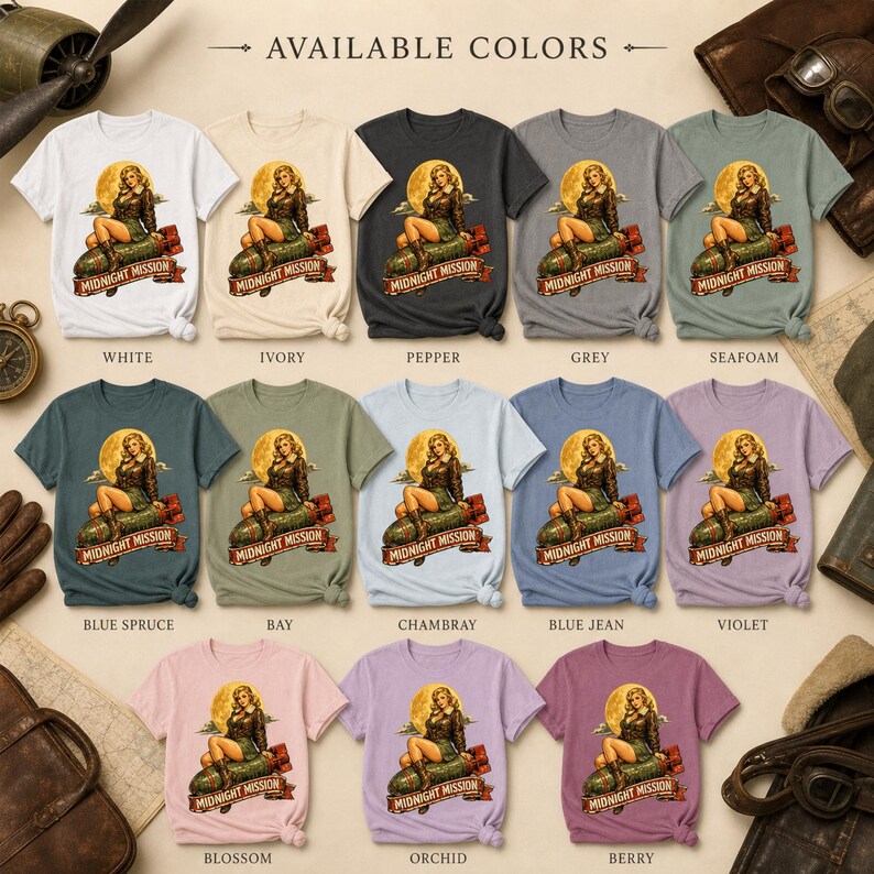 Peut inclure: Une collection de treize t-shirts &agrave; manches courtes de diff&eacute;rentes couleurs, chacun arborant un motif repr&eacute;sentant une personne pin-up assise sur une bombe avec le texte Midnight Mission. Les couleurs incluent blanc, ivoire, poivre, gris, &eacute;cume de mer, &eacute;pic&eacute;a bleu, baie, chambray, jean bleu, violet, fleur, orchid&eacute;e et baie.