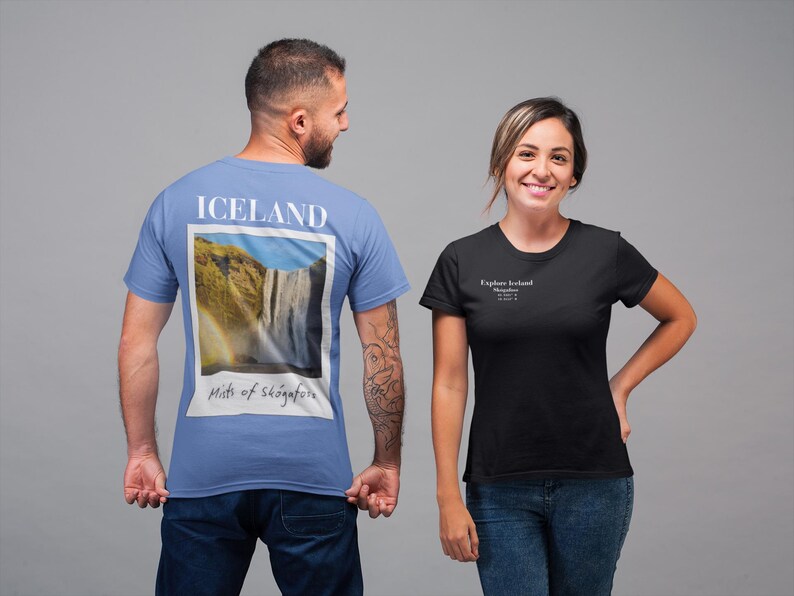 May include: Two people wearing t-shirts. One is light blue with "ICELAND" and a waterfall image. The other is black with "Explore Iceland" text. Both shirts are short-sleeved and made of a soft material.