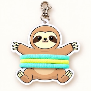 May include: A sloth-shaped acrylic keychain display card featuring a cartoon sloth with brown fur and a cream face. The sloth is holding three coiled hair ties: two turquoise ones on the top and bottom, and one bright yellow one in the middle.