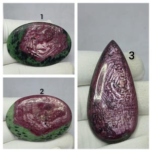 May include: Three polished cabochon gemstones labeled 1, 2, and 3. Items 1 and 2 are oval-shaped with a central deep red hexagonal pattern surrounded by green zoisite. Item 3 is a teardrop-shaped stone with a deep red, textured hexagonal surface.