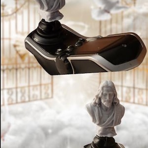 May include: A religious-themed decorative item featuring a bust of Jesus Christ atop a black and silver base. The background includes a heavenly scene with clouds and a dove, suggesting a spiritual theme.