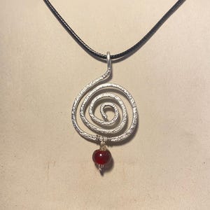 Handmade pendant necklace with a red bead