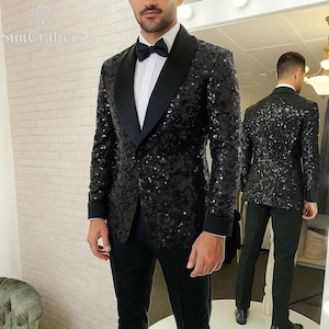 May include: A black sequin tuxedo jacket with a black satin lapel, worn with a white dress shirt and black bow tie. The jacket is paired with black trousers. The image shows the front and back of the jacket.