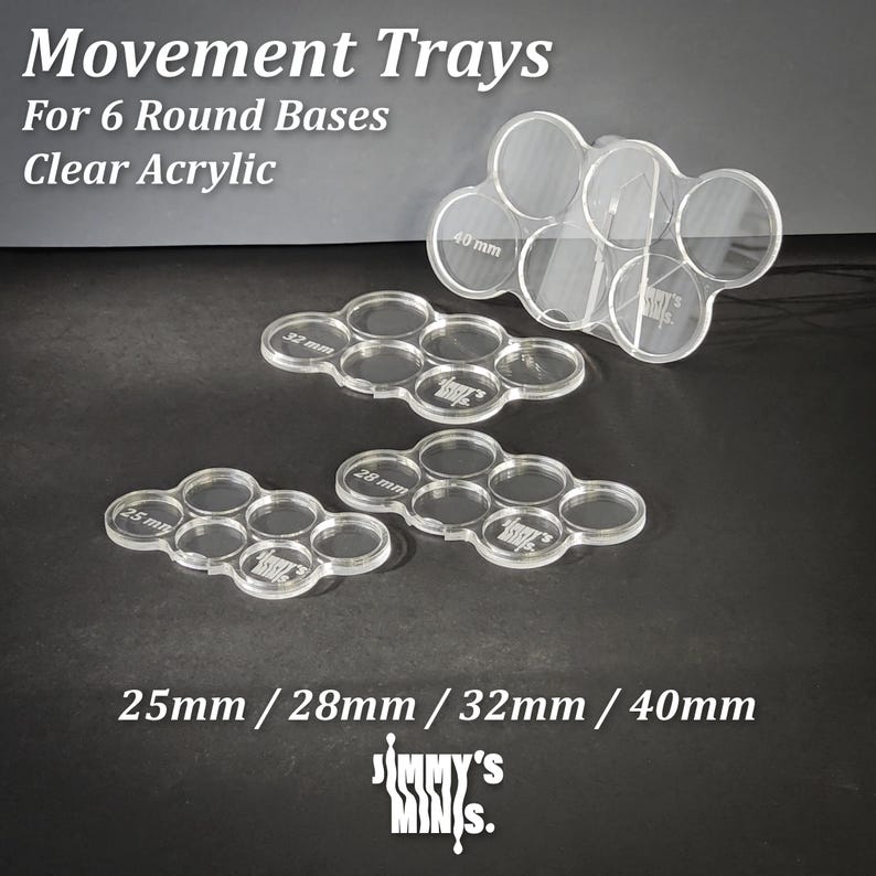 May include: Clear acrylic movement trays for 6 round bases. Sizes include 25mm, 28mm, 32mm, and 40mm. The trays are designed to hold miniatures. The text on the image reads "Movement Trays For 6 Round Bases Clear Acrylic".