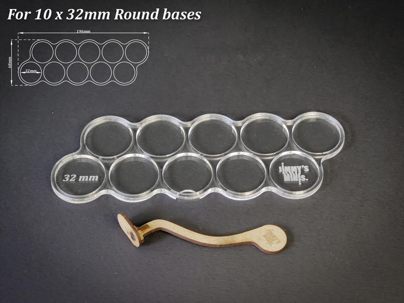 May include: Clear acrylic base holder for 10 x 32mm round bases, with a wooden tool. The holder has 10 circular cutouts, each 3.2 cm in diameter. The text "For 10 x 32mm Round bases" is at the top.