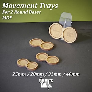 May include: MDF movement trays for two round bases. The trays are light brown with circular cutouts for 25mm, 28mm, 32mm, and 40mm bases. The text "Movement Trays" and "Jimmy's Minis" are visible.