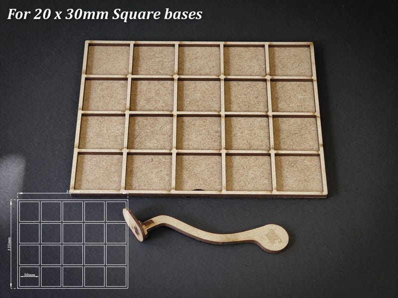 Puede incluir: Una bandeja de madera con 25 compartimentos cuadrados, dise&ntilde;ada para bases cuadradas de 20 x 30 mm. Incluye un asa de madera curvada y un diagrama que muestra las dimensiones. El texto "For 20 x 30mm Square bases" est&aacute; en la parte superior.