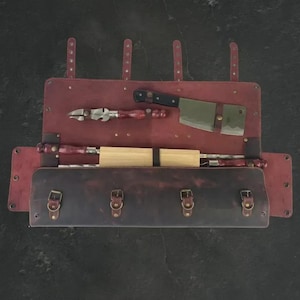 May include: A white ceramic mug with a black handle and the text "But First, Coffee" in a bold, black font. The mug is filled with a dark liquid, probably coffee, and rests on a light-coloured surface.