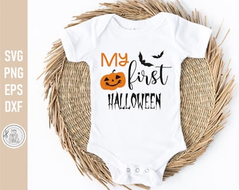 May include: White baby onesie with the text "My first Halloween" in black. A smiling orange pumpkin and two black bats are also on the onesie.